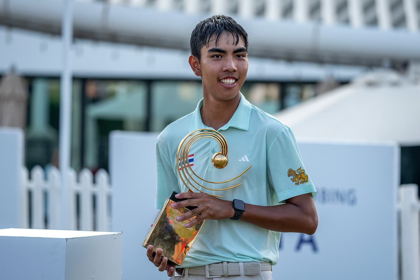 Fifa Laopakdee of Thailand lifts the Asia-Pacific Amateur Championship trophy